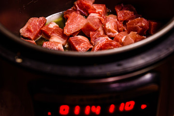 Pork meat preparing in a slow cooker