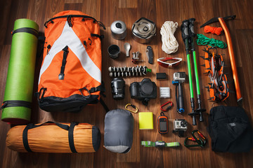 climbing equipment: rope, trekking shoes, crampons, ice tools, ice ax, ice screws, set on dark...
