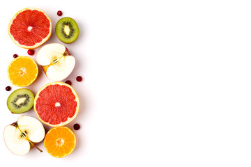 Background of the halves of ripe fruit, kiwi, apples, grapefruit and Mandarin on white.