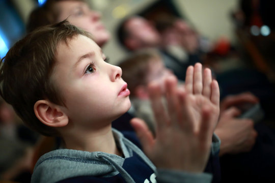 Boy applauding in theater