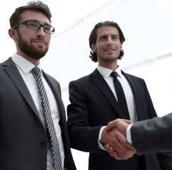 business group welcomes partner with a handshake