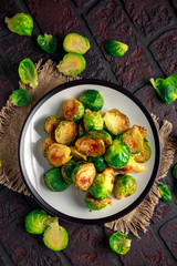 Homemade Roasted Brussel Sprouts with Salt, Pepper on a old stone rustic table.