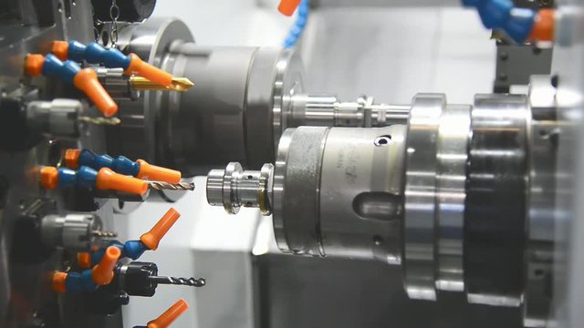 The CNC lathe chucking the steel rod and drilling process operation.Hi-technology manufacturing process .