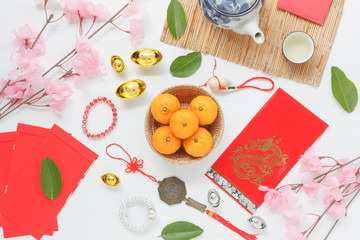 Fototapeta na wymiar Table top view aerial of accessories and Chinese new year and Lunar new year festival concept background.Mix variety object for the season.Difference items on modern white wood at home office desk.