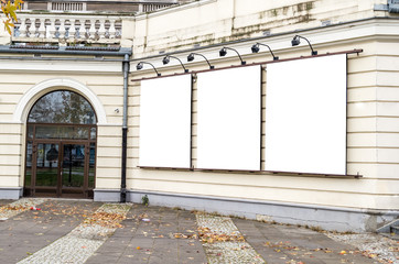 Three blank white film posters hanging on the building of cinema, isolated clipping path