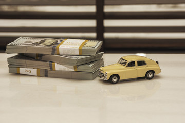 Toy car model with American banknotes, the concept of buying a car.