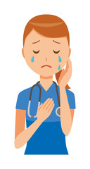 A woman nurse wearing a blue scrub is crying
