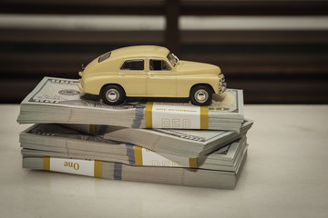 Toy car model with American banknotes, the concept of buying a car.