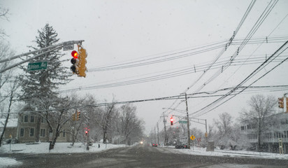 waiting at a traffic in light in the snowstorm