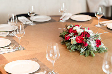 Winter decor. The composition of the branches Nobilis and fresh flowers. For decorating a family dinner