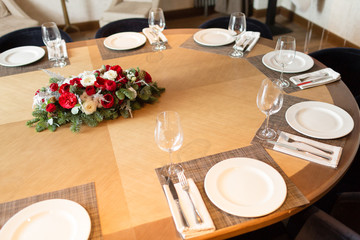 Winter decor. The composition of the branches Nobilis and fresh flowers. For decorating a family dinner