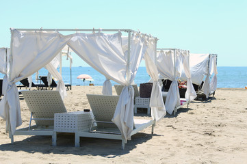 luxury beach in the tropical resort with white umbrellas and bea