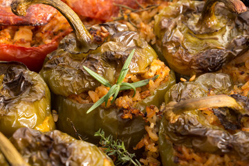 Stuffed green bell peepers in dish, closeup background.