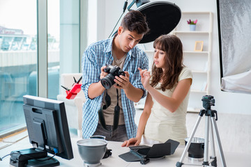 Young photographer working in photo studio