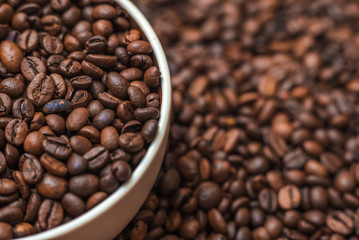 Ceramic cup filled with coffee beans close up. Beverages menu design. Place for text.