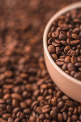 Ceramic cup filled with coffee beans close up. Beverages menu design. Place for text.