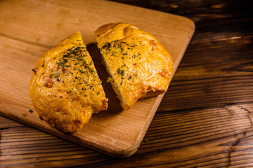 Italian bun ciabatta with garlic on wooden table