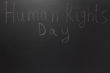 Human rights concept: The text: Human rights day written on blackboard.