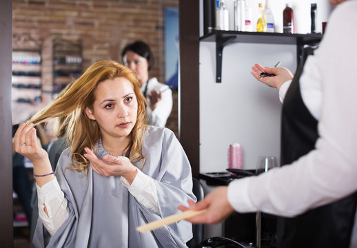 Unhappy woman in hairdress salon