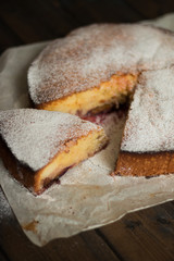 charlotte pie with plums in powdered sugar