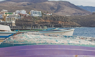 Small boats overturned on the beach.