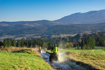 quad driving a dirt road in the mountains © Mike Mareen