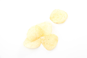 Crispy thinly sliced potato chips, on white background.