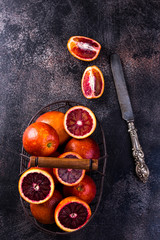 Sicilian oranges on a black slate background.