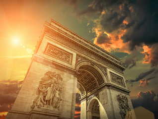 Arc de Triomphe in Paris under sky with clouds. One of symbols o - obrazy, fototapety, plakaty