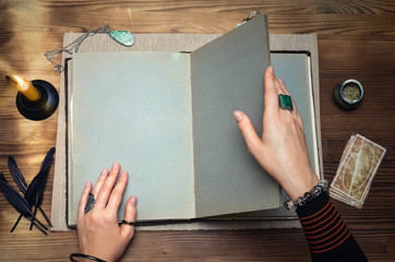 Book of magic. Tarot cards on fortune teller desk table. Future reading. Woman witch reads a...