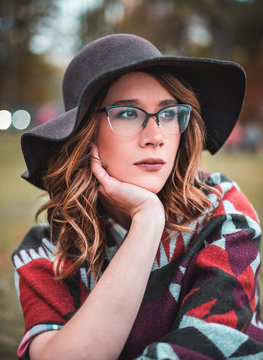  Pretty girl with glasses and hat  closeup portrait outdoors in the green park in autumn
