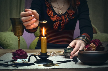 Fototapeta na wymiar Woman witch prepare a magic potion. Future reading. Tarot cards on fortune teller desk table.