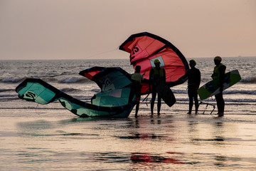 Early evening kite surfing as the sun starts to set over the ocean