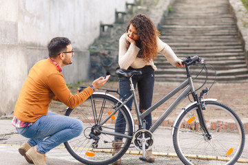 Fototapeta premium Happy young couple with a bicycle on sunny autumn day in the city. 