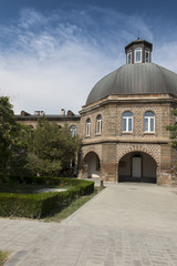 Fototapeta na wymiar Building of the Gevorgyan Spiritual Academy in the park in Etchmiadzin