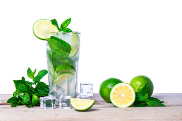 Mojito cocktail with fresh lime, mint leaves and ice cubes in a transparent glass on a wooden background. Refreshing alcohol drink. Isolated on white background.