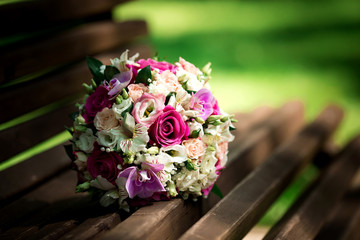 Wedding bouquet of pink and white roses lying on grass