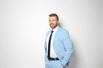 Attractive man in formal suit on white background