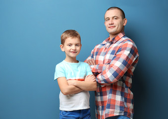 Fototapeta premium Dad and his son on color background