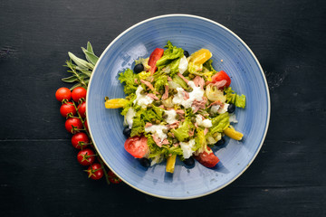 Vegetable salad and mozzarella, tuna and capers. Italian cuisine. Free space for your text. Top view.