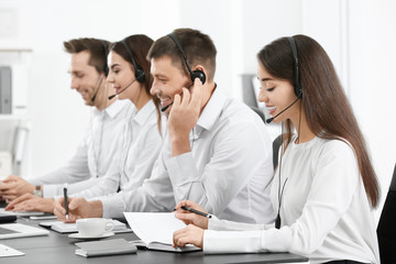 Fototapeta premium Consulting managers with headsets in office