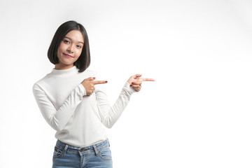 Beautiful young asian woman  pointing at whitespace