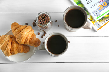 Ceramic cups with delicious coffee on table