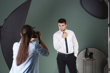 Young man posing for professional photographer in studio