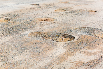 Pothole in pavement signifying failing infrastructure
