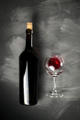 Red wine bottle on a wooden background