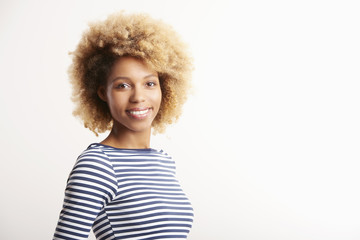 Confident young woman standing against white isolated background