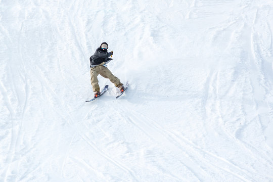 People are having fun in downhill skiing and snowboarding