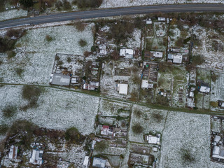 Aerial view of allotment in winter with snow covered roofs