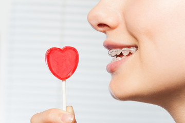 Woman profile with red lollipop in shape of heart